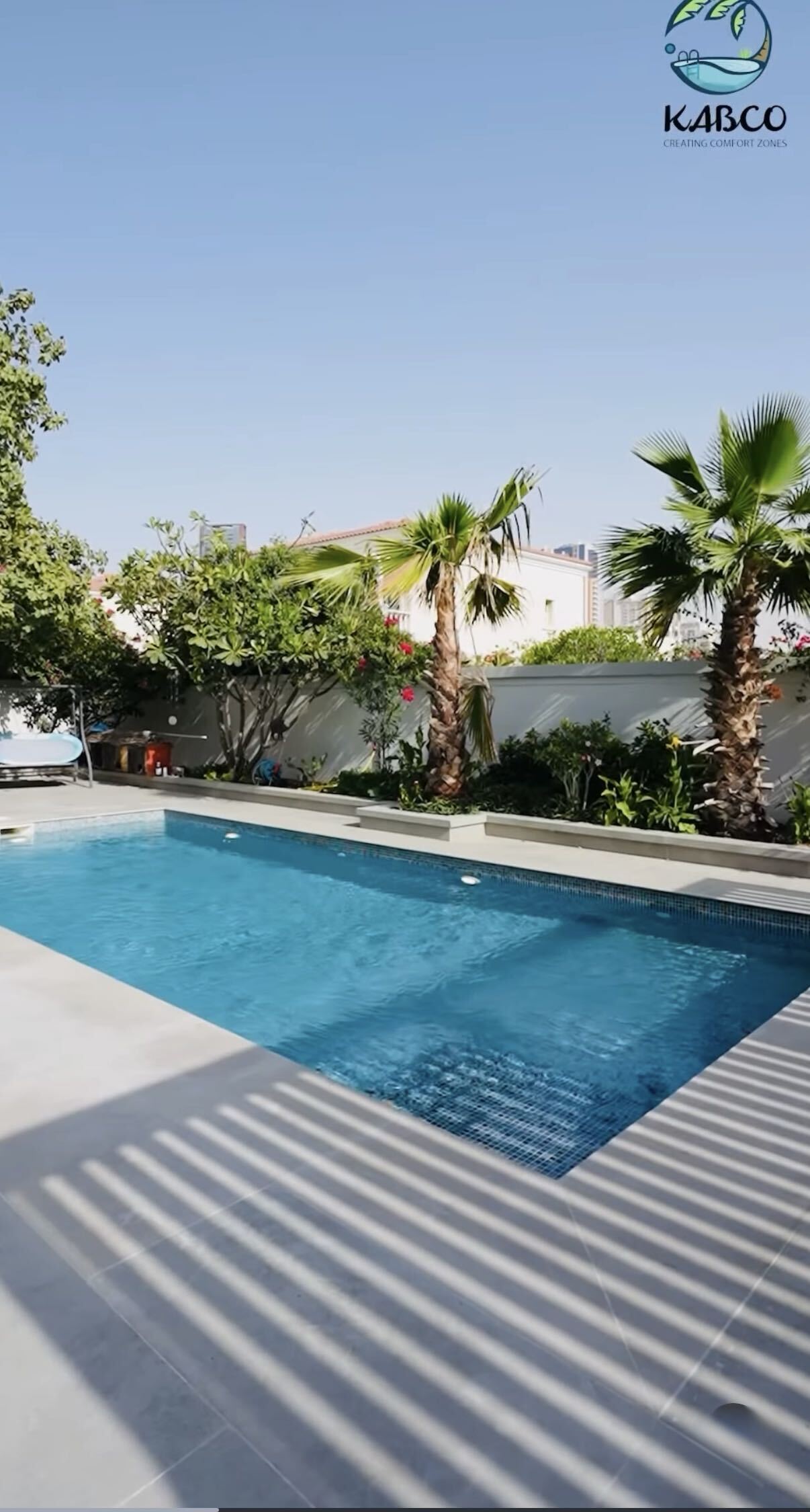 concrete swimming pool with deck and landscaping at a Dubai villa, illustrating the cost of pool construction in 2026